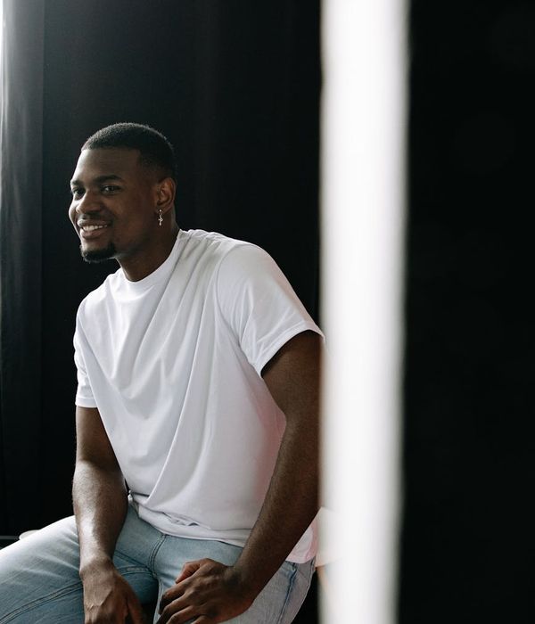 Man video editor smiling confidently in creative studio